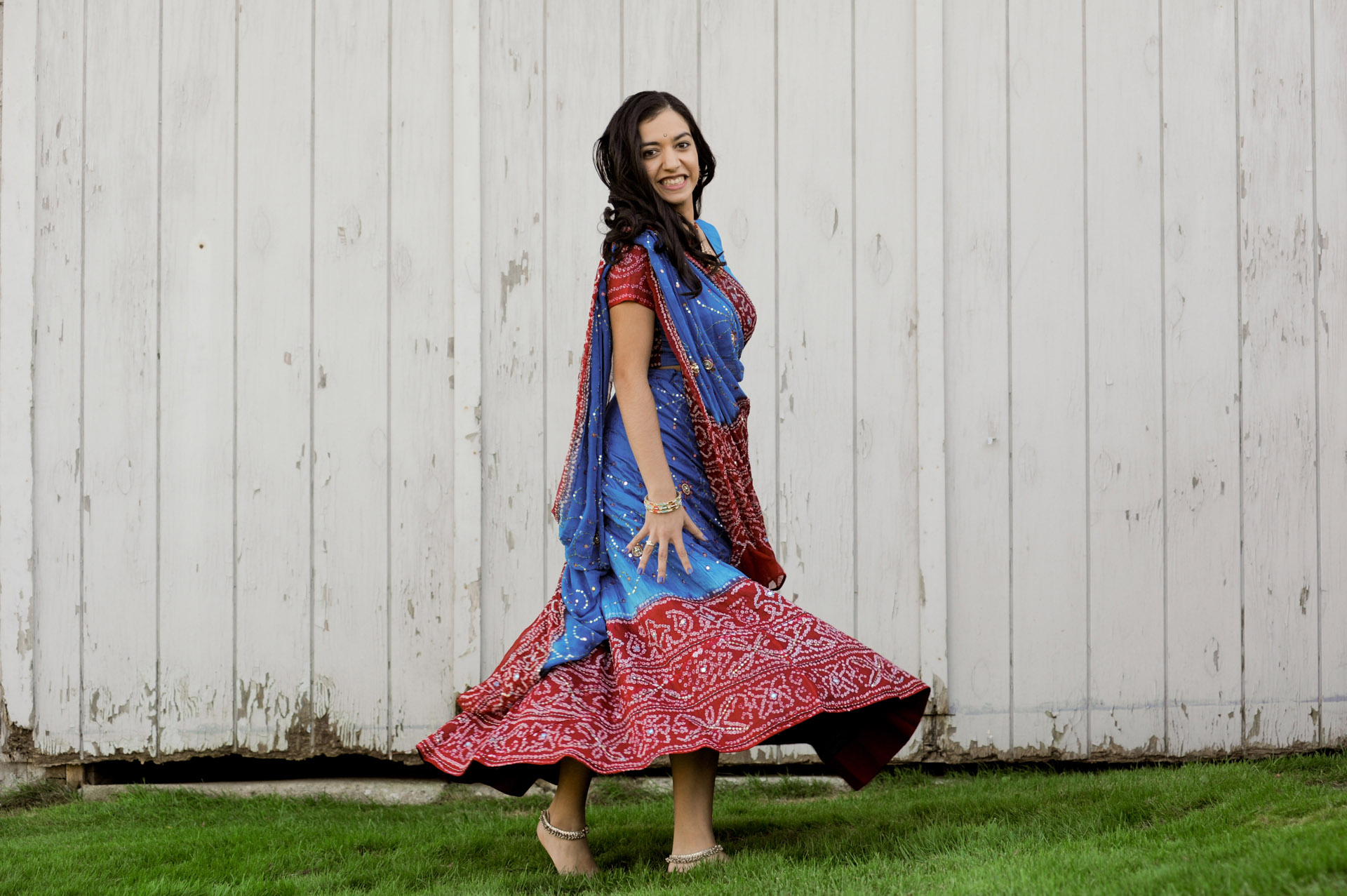 Troy, Michigan senior photographer's photo of a high school senior of her Indian dancing for her senior pictures in Troy, Michigan.